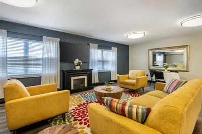 a living room with yellow furniture and a fireplace at Orbit One Vacation Villas in Orlando
