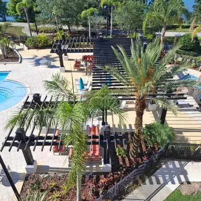 a group of benches and palm trees in a park at 13-403 Your Vista Cay Home in Orlando