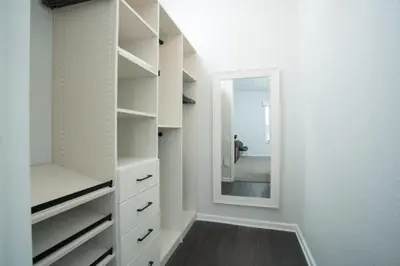 a white closet with a mirror and a hallway at 2-403 Your Vista Cay Condo in Orlando