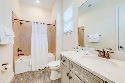 a bathroom with a sink and a toilet and a shower at Sandy Cottage! 3 Miles From Disney With Margaritaville Resort & Island H2O Access - 8080Dr in Orlando