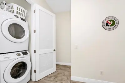 a laundry room with a washer and dryer at Teenie Bikini Cottage With Private Hot Tub Near Disney With Margaritaville Resort & Island H2O Access - 3071Kl in Orlando