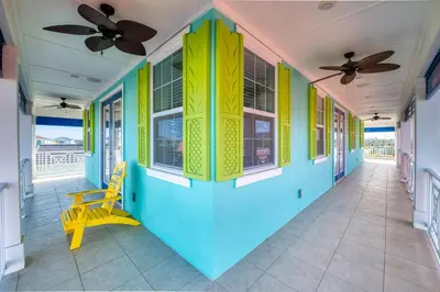 a colorful hallway with a yellow chair and windows at Bikini Bay Cottage With Private Pool Near Disney And Margaritaville Resort & Island H20 Waterpark Access - 3094Ph in Orlando