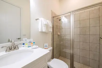 a bathroom with a shower and a sink and a toilet at Bikini Bay Cottage With Private Pool Near Disney And Margaritaville Resort & Island H20 Waterpark Access - 3094Ph in Orlando