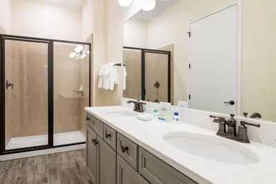 a bathroom with two sinks and a shower at Lovely Cottage 3 Miles From Disney W Hot Tub And Margaritaville Resort & Island H2O Access - 8092Dr in Orlando