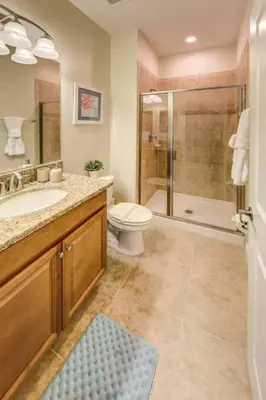 a bathroom with a toilet and a sink and a shower at Storey Lake 4b3b town home with private pool in Kissimmee