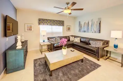 a living room with a couch and a table at Storey Lake 4b3b town home with private pool in Kissimmee