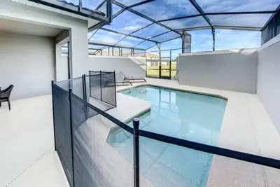 an indoor swimming pool with a glass roof at Storey Lake 4b3b town home with private pool in Kissimmee