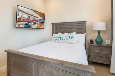 a bedroom with a bed with a wooden headboard at Cozy Cottage With Hot Tub Near Disney With Margaritaville Resort & Island H2O Access - 8056Dr in Orlando