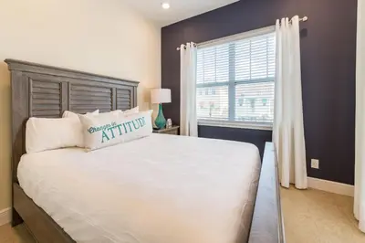 a bedroom with a large bed and a window at Cozy Cottage With Hot Tub Near Disney With Margaritaville Resort & Island H2O Access - 8056Dr in Orlando