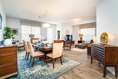 a dining room and living room with a table and chairs at Orlando Escape in Orlando
