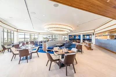 a restaurant with tables and chairs and windows at Paradise Cottage With Private Pool Near Disney And Margaritaville Resort & Island H20 Waterpark Access - 7989Su in Orlando