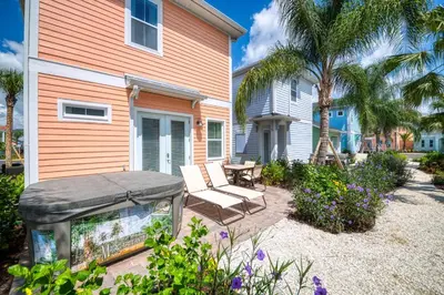 a house with a patio with a bench and a table at Tropical Oasis Cottage With Private Hot Tub Near Disney With Margaritaville Resort & Island H2O Access - 3021La in Orlando