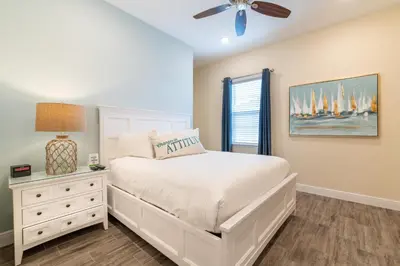 a bedroom with a white bed and a ceiling fan at Nautical Cottage With Private Hot Tub Near Disney With Margaritaville Resort & Island H2O Access - 3044Sr in Orlando
