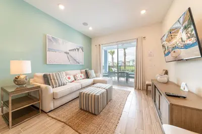 a living room with a couch and a table at Waterfront Cottage With Private Pool Near Disney And Margaritaville Resort & Island H20 Access - 7985Su in Orlando