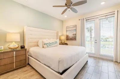 a bedroom with a bed and a ceiling fan at Spacious Cottage With Private Pool Near Disney With Margaritaville Resort & Island H2O Access - 8009Su in Orlando