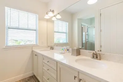 a bathroom with two sinks and a large mirror at Spacious Cottage With Private Pool Near Disney With Margaritaville Resort & Island H2O Access - 8009Su in Orlando