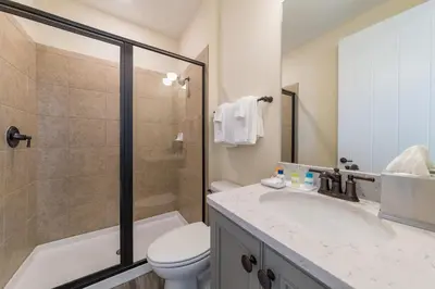 a bathroom with a sink and a toilet and a shower at Bon Voyage Cottage With Private Pool Near Disney With Margaritaville Resort & Island H2O Access - 8045Su in Orlando