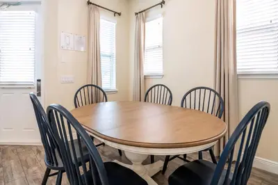 a dining room with a wooden table and chairs at Casa Del Mar Cottage Near Disney With Margaritaville Resort & Island H2O Access - 8009Ff in Orlando