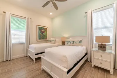 a bedroom with two beds and a ceiling fan at We Be Jammin Cottage With Private Hot Tub Near Disney With Margaritaville Resort & Island H2O Access - 8020Dr in Orlando