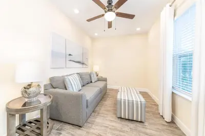 a living room with a couch and a ceiling fan at Fun In The Sun Cottage With Private Pool Near Disney With Margaritaville Resort & Island H2O Access - 8052Sh in Orlando