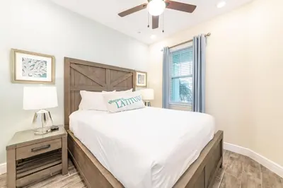 a bedroom with a large bed and a window at Fun In The Sun Cottage With Private Pool Near Disney With Margaritaville Resort & Island H2O Access - 8052Sh in Orlando