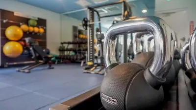 a gym with several rows of machines at Fun In The Sun Cottage With Private Pool Near Disney With Margaritaville Resort & Island H2O Access - 8052Sh in Orlando