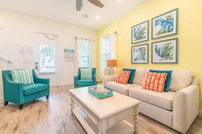 a living room with a couch and two chairs at Island Time Cottage With Hot Tub Near Disney With Margaritaville Resort & Island H2O Access - 8040Su in Orlando