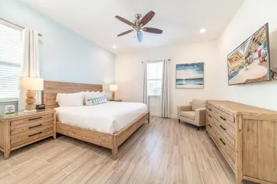 a bedroom with a bed and a ceiling fan at Ocean Waves Cottage With Private Pool Near Disney With Margaritaville Resort & Island H2O Access - 8001Su in Orlando