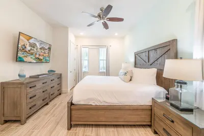 a bedroom with a bed and a ceiling fan at Ocean Waves Cottage With Private Pool Near Disney With Margaritaville Resort & Island H2O Access - 8001Su in Orlando