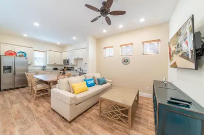 a living room with a couch and a table at Parrot Bay Cottage With Private Hot Tub Near Disney With Margaritaville Resort & Island H2O Access - 3067Kl in Orlando