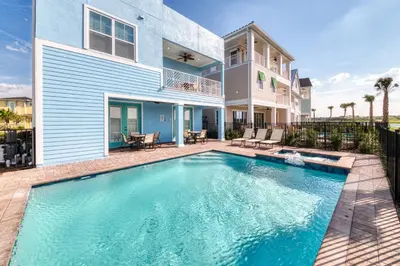 a swimming pool in front of a house at High Tide Cottage With Private Pool Near Disney With Margaritaville Resort & Island H2O Access - 8053Su in Orlando