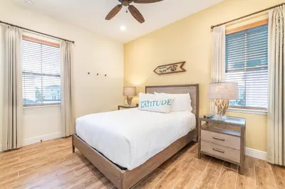 a bedroom with a bed and a ceiling fan at Fiesta Siesta Cottage With Hot Tub Near Disney With Margaritaville Resort & Island H2O Access - 8068Dr in Orlando
