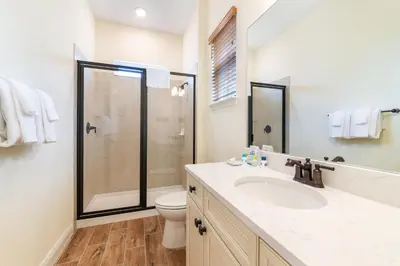 a bathroom with a toilet and a sink and a shower at Fiesta Siesta Cottage With Hot Tub Near Disney With Margaritaville Resort & Island H2O Access - 8068Dr in Orlando