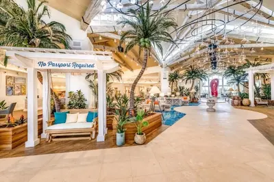 a large lobby with palm trees and plants at Fiesta Siesta Cottage With Hot Tub Near Disney With Margaritaville Resort & Island H2O Access - 8068Dr in Orlando