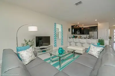 a living room with a couch and a table at 891Pbeach Amazing Champions Gate 8 Bedroom 5 Bed Villa in Orlando