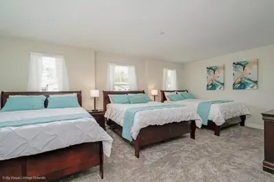 a bedroom with two beds and two windows at 891Pbeach Amazing Champions Gate 8 Bedroom 5 Bed Villa in Orlando