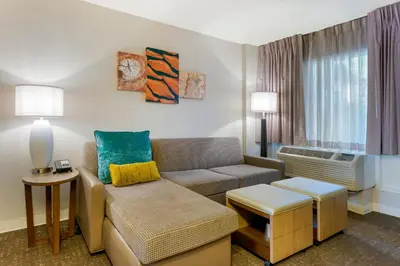 a living room with a couch and a table at Staybridge Suites Orlando Royale Parc Suites by IHG in Orlando