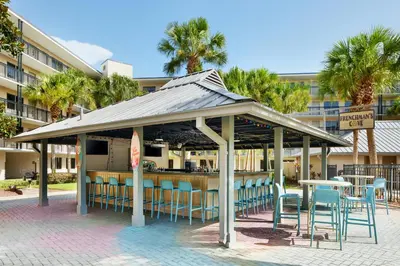 a gazebo with chairs and tables and a bar at Staybridge Suites Orlando Royale Parc Suites by IHG in Orlando