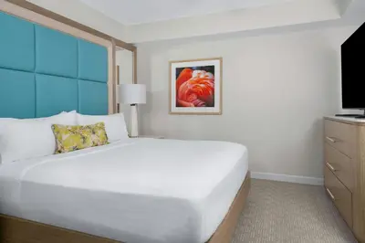 a bedroom with a large white bed and a television at Gaylord Palms Resort & Convention Center in Orlando