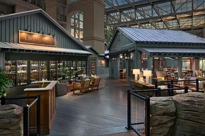 a restaurant in a building with people sitting in chairs at Gaylord Palms Resort & Convention Center in Orlando