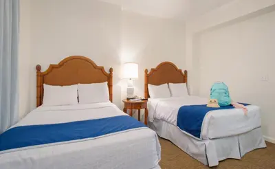 two beds in a hotel room with a toy on the bed at Lake Buena Vista Resort Village and Spa, Near Disney in Orlando