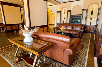 a living room with a leather couch and a table at Lake Buena Vista Resort Village and Spa, Near Disney in Orlando