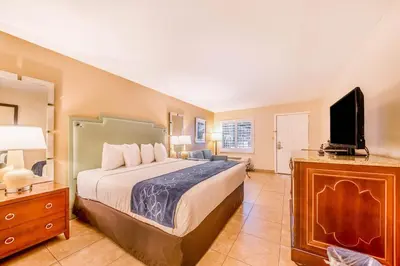 a bedroom with a bed and a flat screen tv at Seasons Florida Resort in Kissimmee