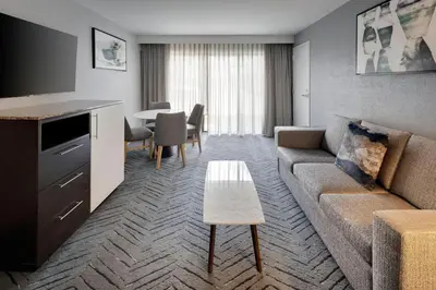 a living room with a couch and a table at Delta Hotels by Marriott Orlando Celebration in Orlando
