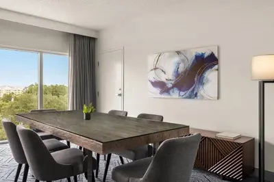 a dining room with a table and chairs at Delta Hotels by Marriott Orlando Celebration in Orlando