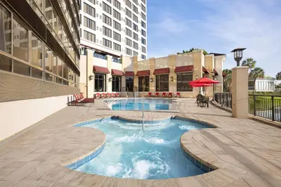 a swimming pool in the middle of a building at Ramada Plaza by Wyndham Orlando Resort & Suites Intl Drive - Newly Renovated! in Orlando