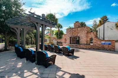 a group of chairs under a pergola on a patio at FantasyWorld Resort in Kissimmee