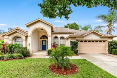 a large house with a garage at #503 Stunning 4 Bed, 3 bath villa with southwest facing pool and spa in Orlando