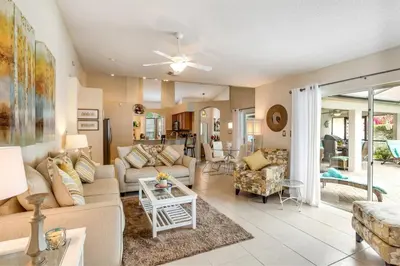 a living room with a couch and a table at #503 Stunning 4 Bed, 3 bath villa with southwest facing pool and spa in Orlando