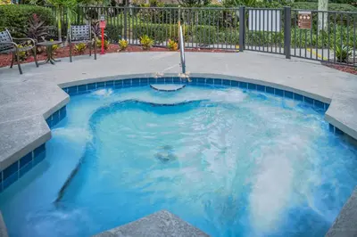a small pool with blue water in a patio at Hilton Vacation Club Polynesian Isles Kissimmee in Kissimmee